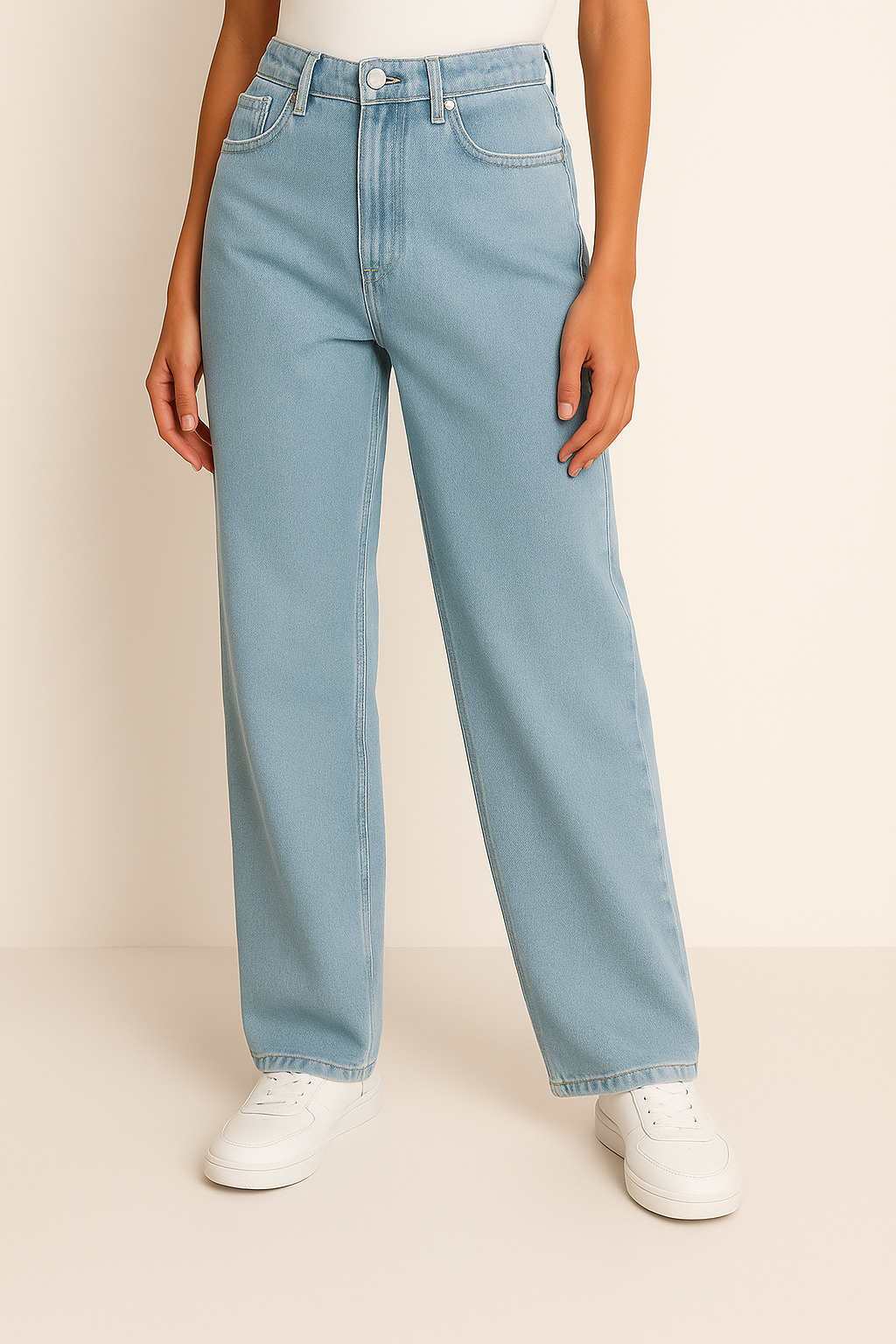 Light blue jeans worn by a person on a beige background

